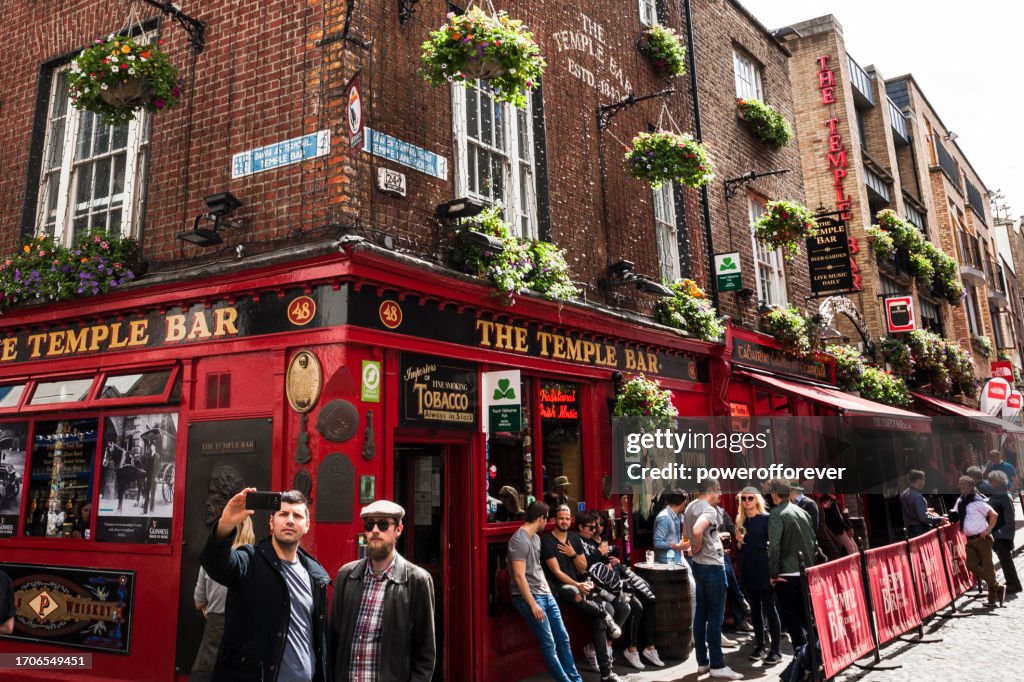 Tourists Taking a Selfie at Temple Bar Pub in Dublin, Ireland