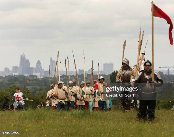 Re-enactors in period costume return from staging a medieval battle at Eltham Palace on June 16, 2013 in Eltham, England. The 'Grand Medieval Joust'...