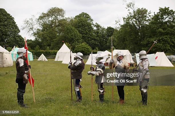 Re-enactors in suits of armour prepare to stage a medieval battle at Eltham Palace on June 16, 2013 in Eltham, England. The 'Grand Medieval Joust'...