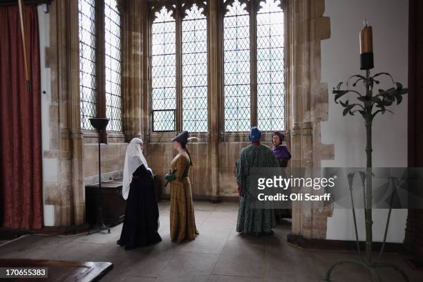 Re-enactors in period costume prepare to demonstrate medieval dance in the Great Hall at Eltham Palace on June 16, 2013 in Eltham, England. The...