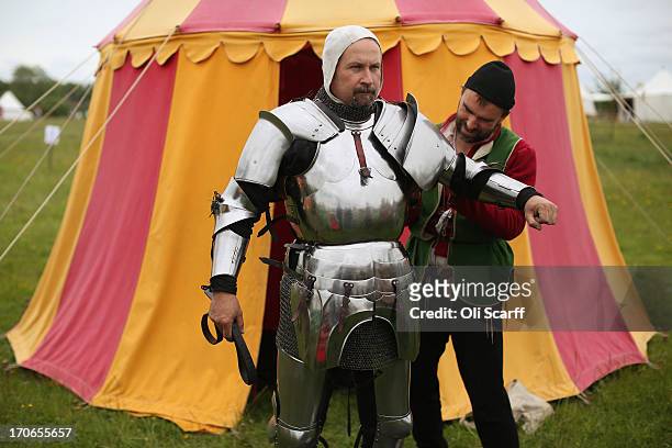 Re-enactor dresses as a knight before staging a medieval jousting competition at Eltham Palace on June 16, 2013 in Eltham, England. The 'Grand...