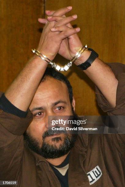 Senior Palestinian activist Marwan Barghouti raises his arms in triumph after he was brought into court January 2, 2003 in Tel Aviv, Israel....