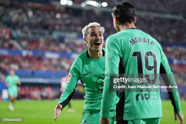 Antoine Griezmann of Atletico Madrid celebrates with teammate Alvaro Morata after scoring the team's first goal during the LaLiga EA Sports match...