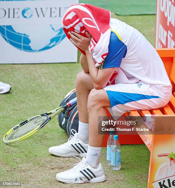 Mikhail Youzhny of Russia sits dejected on a bench in the final match against Roger Federer of Switzerland during the final day of the Gerry Weber...