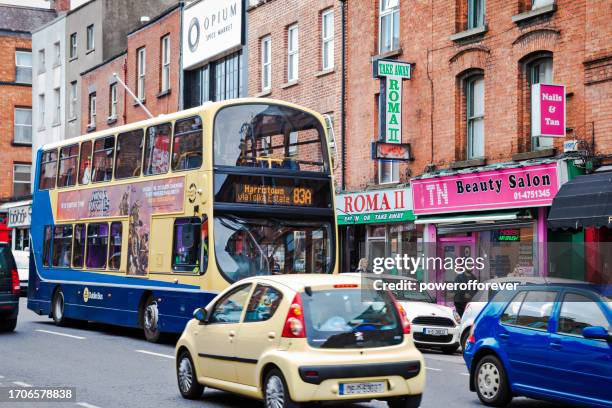 dublin bus on a busy city street in dublin, ireland - dublin bus stock pictures, royalty-free photos & images