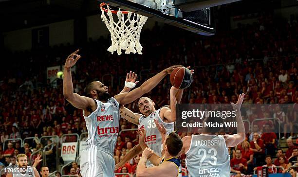 Sharrod Ford , Maik Zirbes and Casey Jacobsen of Bamberg fight for a rebound under the hoop during game 3 of the finals of the Beko BBL playoffs...