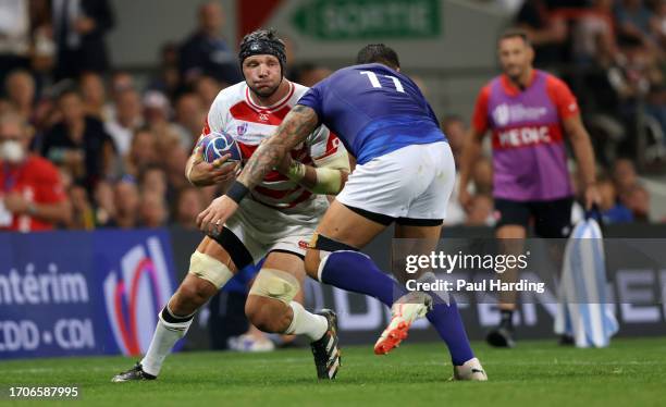 Pieter Labuschagne of Japan is hit by a high tackle from Ben Lam of Samoa which results in a red card during the Rugby World Cup France 2023 match...