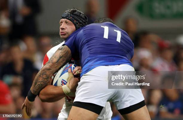 Pieter Labuschagne of Japan is hit by a high tackle from Ben Lam of Samoa which results in a red card during the Rugby World Cup France 2023 match...