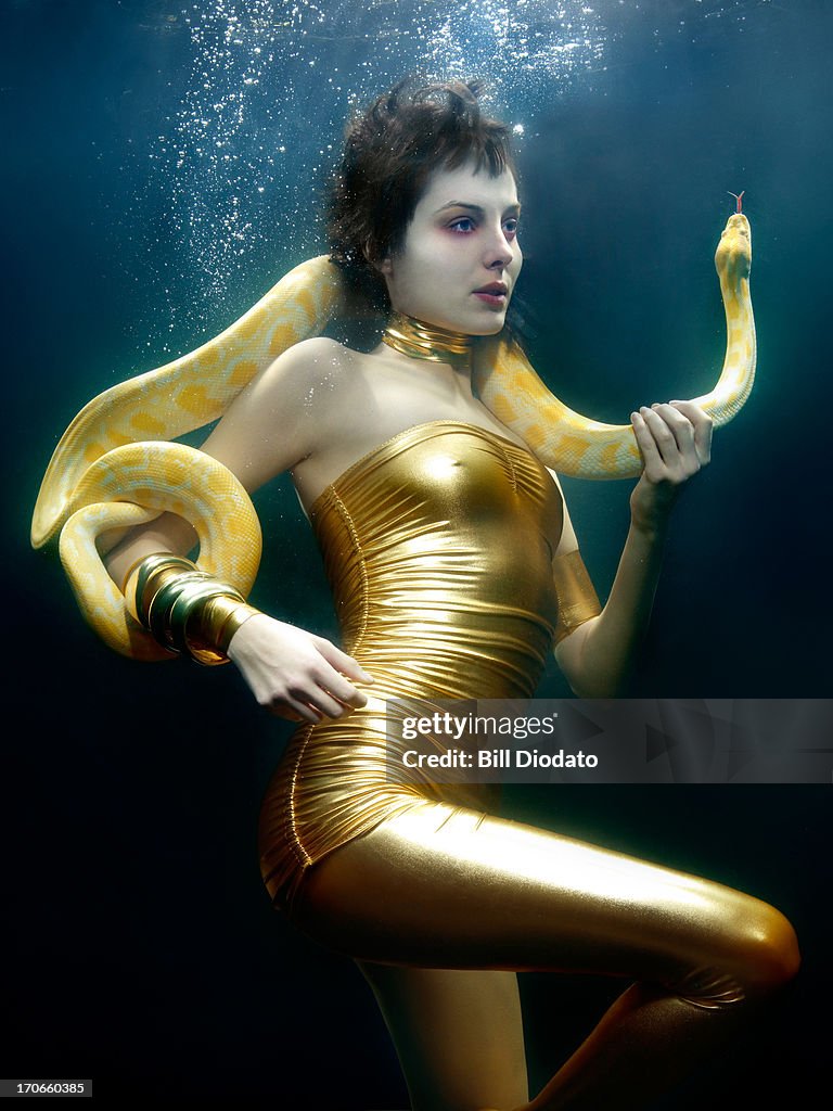 Woman under water with snake