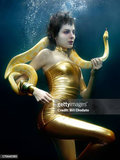 woman under water with snake - underwater female models stock pictures, royalty-free photos & images