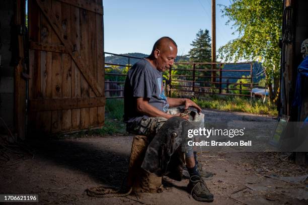 Farmer Steve Vigil sits with his childhood chaps for a portrait during an interview on September 27, 2023 in Cundiyo, New Mexico. "My house was built...