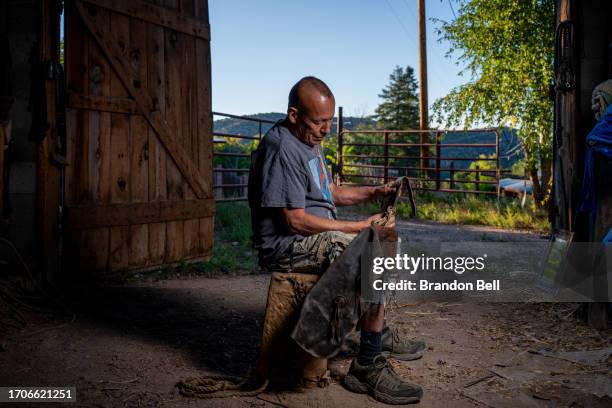 Farmer Steve Vigil sits with his childhood chaps for a portrait during an interview on September 27, 2023 in Cundiyo, New Mexico. "My house was built...