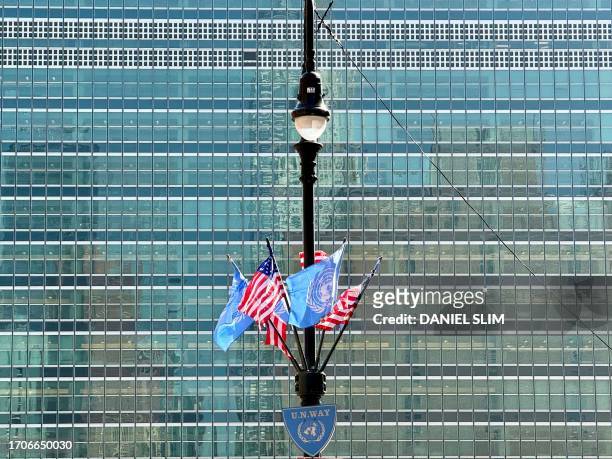 United Nations and US flags are seen in front of UN headquarters in New York on October 4, 2023.