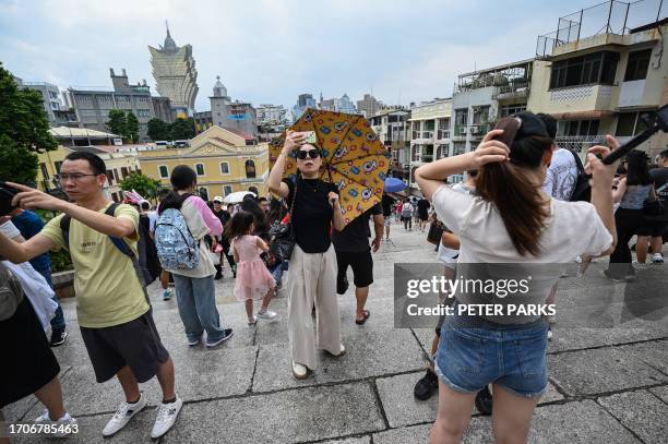 This photo taken on October 3, 2023 shows Chinese tourists visiting Macau during the country's week-long holiday at the start of October. Macau's...