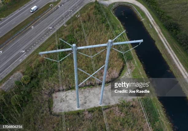 In an aerial view, electric power lines are seen attached to the transmission tower along the power grid on September 28, 2023 in the Everglades,...