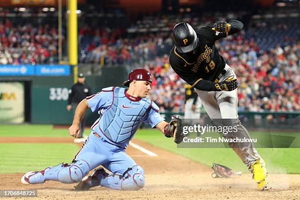 Jared Triolo of the Pittsburgh Pirates scores a run past J.T. Realmuto of the Philadelphia Phillies during the fifth inning at Citizens Bank Park on...