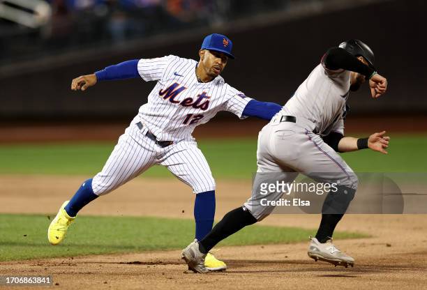 Jon Berti of the Miami Marlins is caught in a rundown as Francisco Lindor of the New York Mets makes the tag in the third inning at Citi Field on...