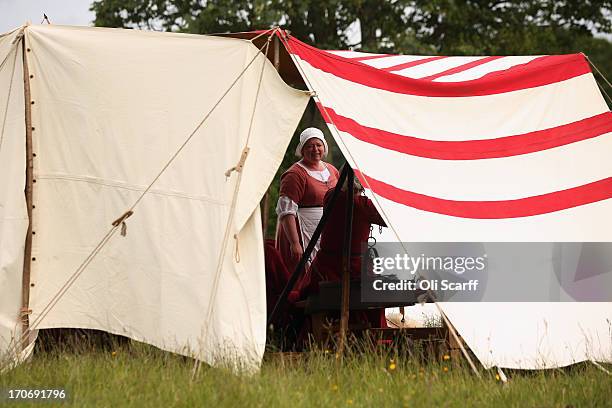 Reenactors in period costume prepare food in a medieval encampment at Eltham Palace on June 16, 2013 in Eltham, England. The 'Grand Medieval Joust'...