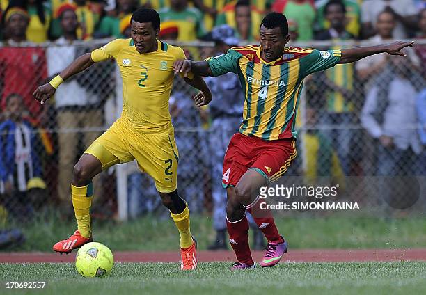 South Africa's Mashendi Sogolela fights for the ball with Ethiopia's Abebaw Butako during the 2014 FIFA World Cup qualifying football match Ethiopia...