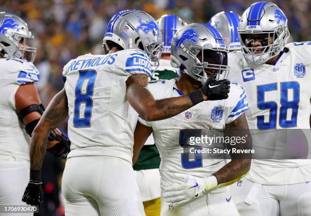 David Montgomery of the Detroit Lions celebrates with Josh Reynolds after scoring a touchdown against the Green Bay Packers during the first quarter...
