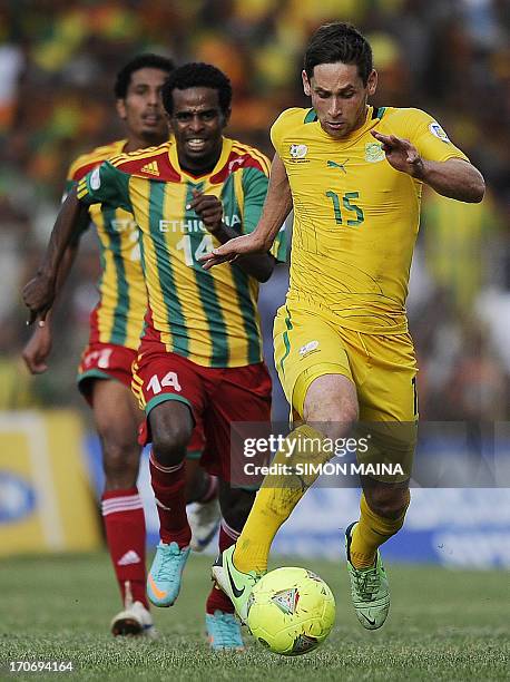 South Africa's Dean Furman runs with the ball past Ethiopia's Minyahil Teshome during the 2014 FIFA World Cup qualifying football match Ethiopia vs...