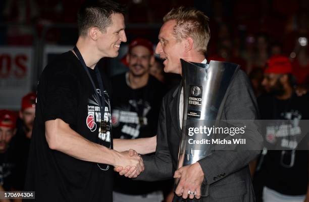 Team captain Casey Jacobsen of Bamberg is presented the Beko BBL Cup from Beko CEO Jan Pommer after winning the finals of the Beko BBL playoffs...