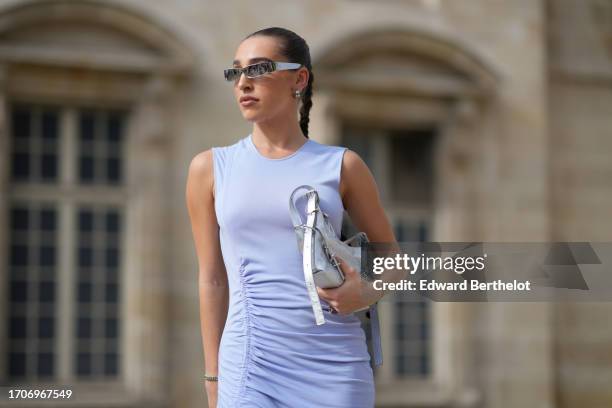 Ginevra Mavilla wears sunglasses, a sleeveless mauve / pastel purple gathered slit dress, , outside Givenchy, during the Womenswear Spring/Summer...