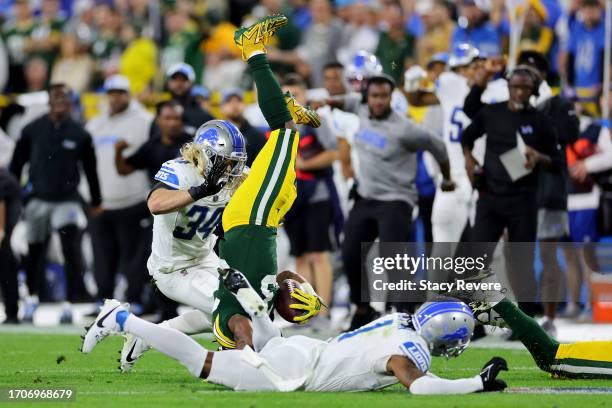 Aaron Jones of the Green Bay Packers flips over after a play against the Detroit Lions during the second quarter in the game at Lambeau Field on...