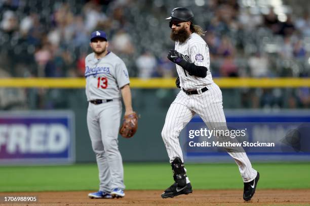 Charlie Blackmon of the Colorado Rockies circles the bases after hitting a home run against the Los Angeles Dodgers in the first inning at Coors...