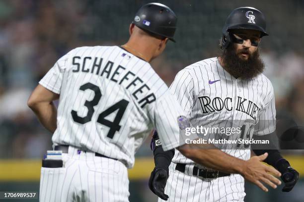 Charlie Blackmon of the Colorado Rockies is congratulated by Warren Schaeffer as hecircles the bases after hitting a home run against the Los Angeles...