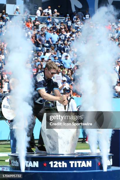 Indy 500 champion Josef Newgarden plunges a sward into a stone while serving as the "12th Titan" during a game between the Tennessee Titans and...