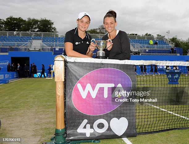 Ashleigh Barty and Casey Dellacqua of Australia celebrate winning the Doubles Final with the Trophy on the Ann Jones Centre Court during the AEGON...