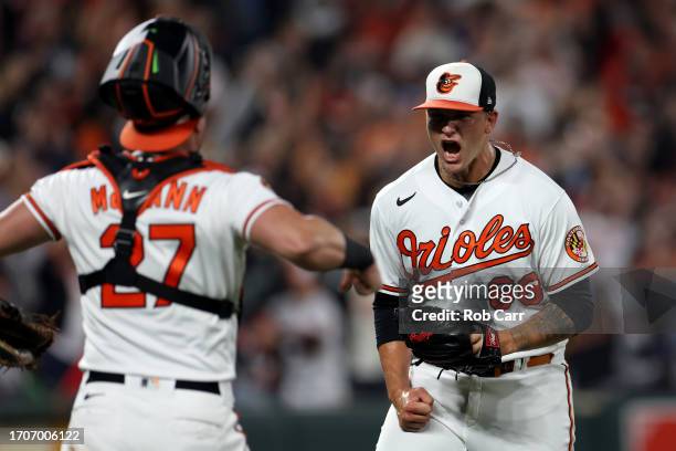 Pitcher Tyler Wells and catcher James McCann of the Baltimore Orioles celebrate after the Orioles defeated the Boston Red Sox to win the the American...