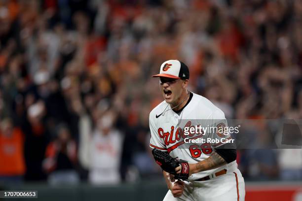 Pitcher Tyler Wells of the Baltimore Orioles celebrates after the Orioles defeated the Boston Red Sox to win the the American League East at Oriole...