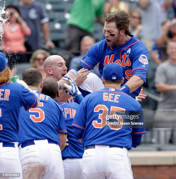 Kirk Nieuwenhuis of the New York Mets celebrates with his teammates at home plate after he connects on a three-run game winning home run against the...