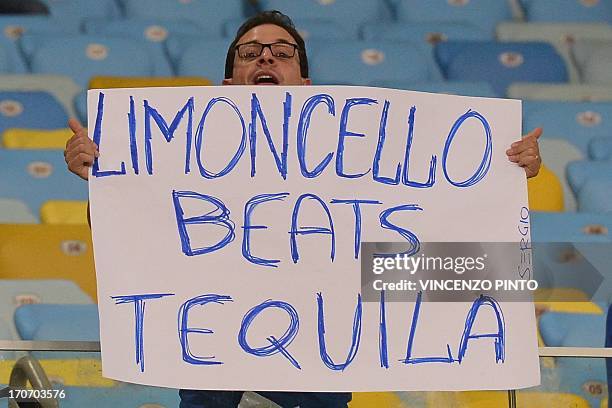 Football fan displays a poster at the end of the FIFA Confederations Cup Brazil 2013 Group A football match between Mexico and Italy, at the Maracana...