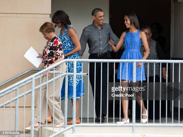 President Barack Obama and his daughter Malia follow U.S. First Lady Michelle Obama and her mother Marian Robinson from the Strathmore Music Center...