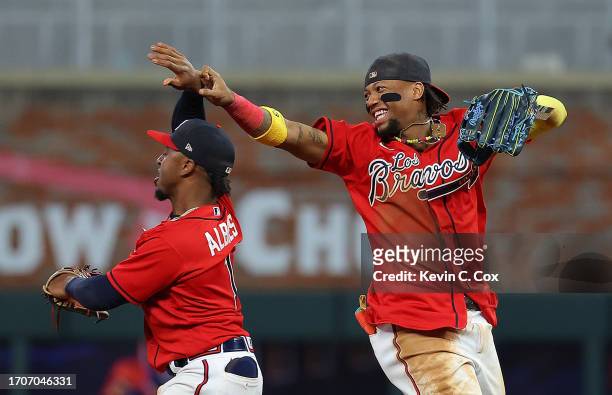 Ronald Acuna Jr. #13 and Ozzie Albies of the Atlanta Braves react after their 5-3 win over the Chicago Cubs at Truist Park on September 28, 2023 in...