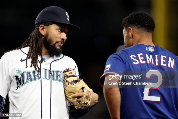 Crawford of the Seattle Mariners and Marcus Semien of the Texas Rangers greet each other during the first inning at T-Mobile Park on September 28,...