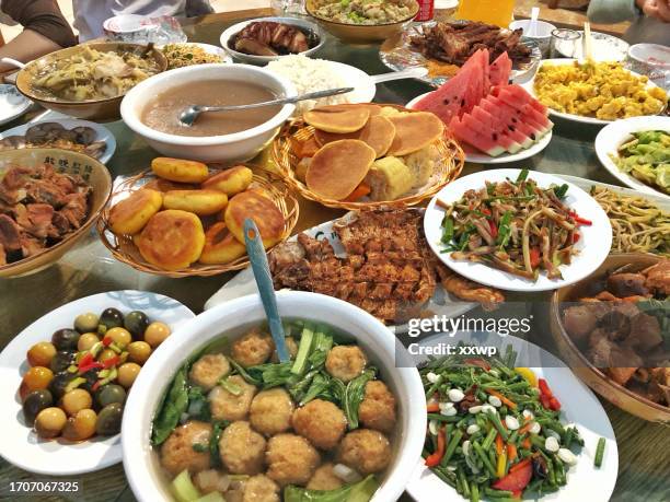 the dining table of the farmhouse is filled with food. - gala table stock pictures, royalty-free photos & images