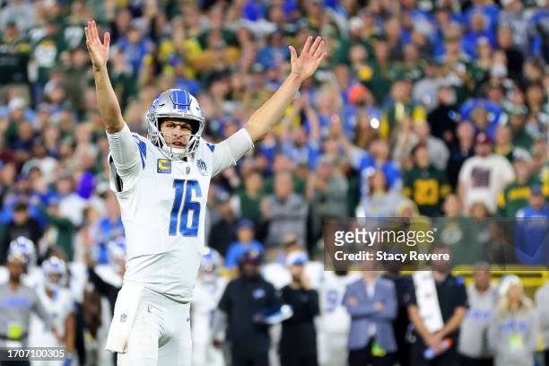 Jared Goff of the Detroit Lions celebrates a touchdown scored by David Montgomery against the Green Bay Packers during the fourth quarter in the game...