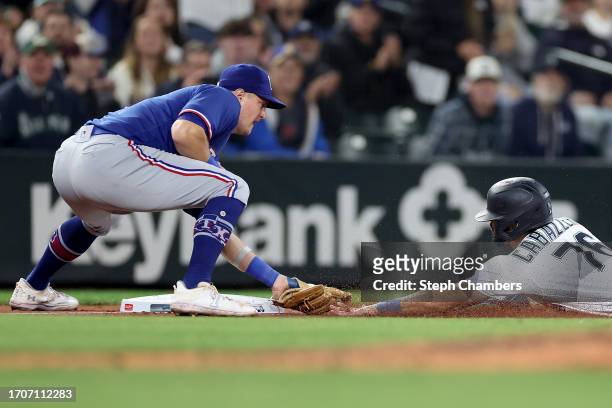 Jose Caballero of the Seattle Mariners is tagged out at third base Josh Jung of the Texas Rangers during the fifth inning at T-Mobile Park on...