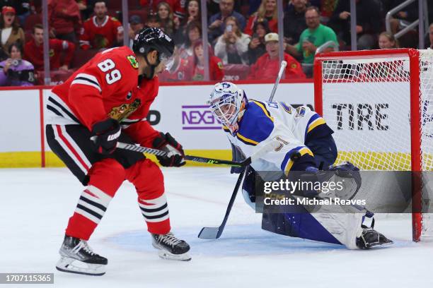 Andreas Athanasiou of the Chicago Blackhawks scores a game-winning goal past Will Cranley of the St. Louis Blues in overtime of a preseason game at...