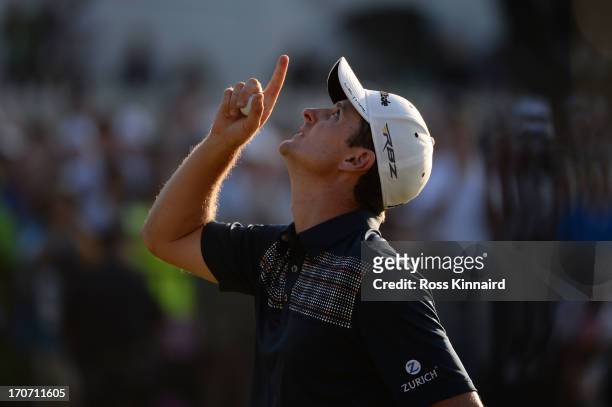 Justin Rose of England looks to the heavens in acknowledgement of his deceased father after putting on the 18th hole to complete the final round of...