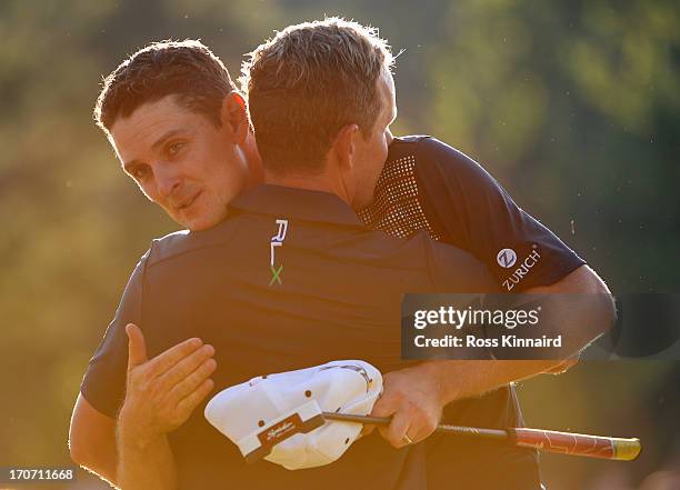 Justin Rose of England embraces caddie Mark Fulcher after putting on the 18th hole to complete the final round of the 113th U.S. Open at Merion Golf...