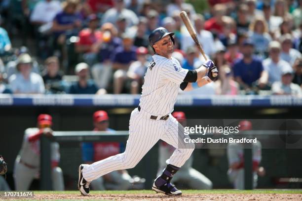 Michael Cuddyer of the Colorado Rockies doubles in the seventh inning of a game against the Philadelphia Phillies at Coors Field on June 16, 2013 in...