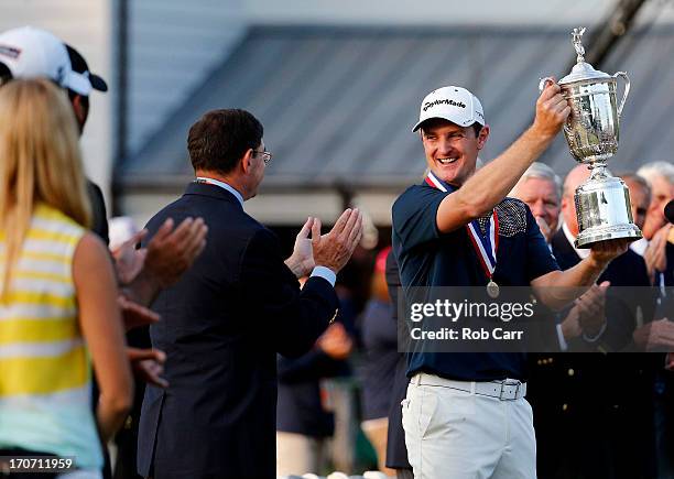 Justin Rose of England celebrates with the U.S. Open trophy after winning the 113th U.S. Open at Merion Golf Club on June 16, 2013 in Ardmore,...