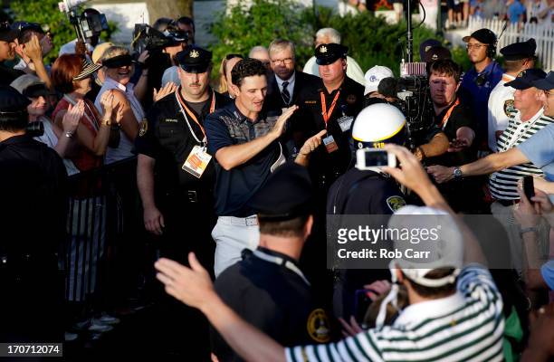 Justin Rose of England is congratulated as he walks to the trophy presentation after winning the 113th U.S. Open at Merion Golf Club on June 16, 2013...
