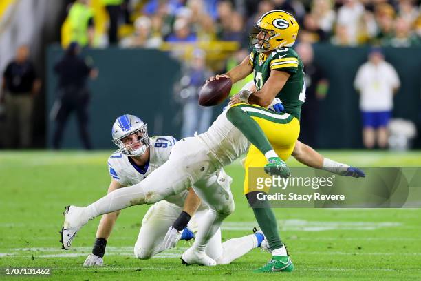 John Cominsky of the Detroit Lions sacks Jordan Love of the Green Bay Packers during the fourth quarter in the game at Lambeau Field on September 28,...