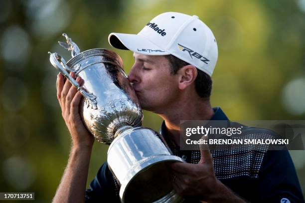 Justin Rose of England kisses the trophy after winning the US Open during the fourth round at Merion Golf Club June 16, 2013 in Ardmore,...